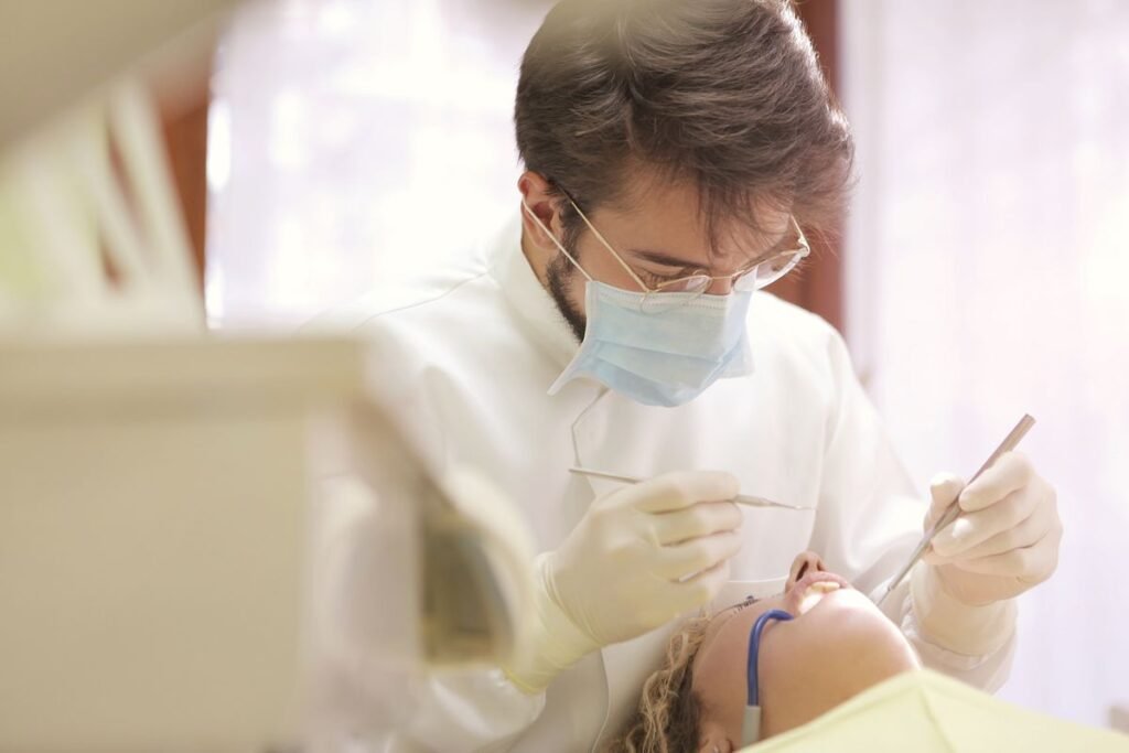 Dentist showing a patient dental implant and bridge tooth replacement options in Aurora