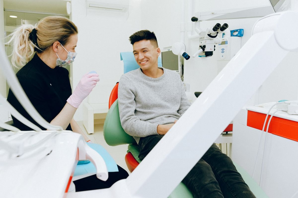 Person holding a custom dental nightguard used to protect teeth from grinding